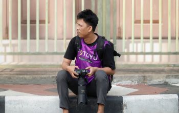 Deko, si fotografer fotoyu lagi nunggu target yang akan diabadikan lewat mata lensa kameranya. (foto.istimewa)